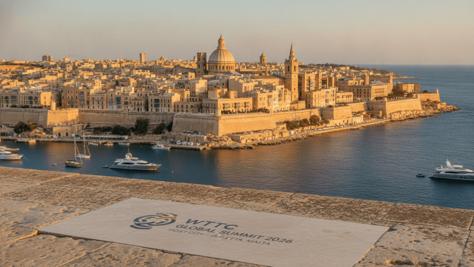 Panoramic view of Valletta, Malta, showing historic golden-hued buildings, fortifications, and a prominent dome against the Mediterranean Sea.
