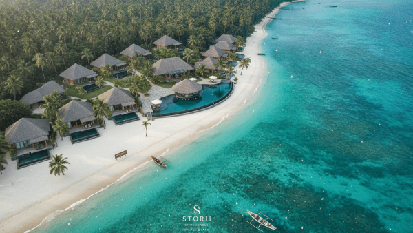 Aerial view of Storii by ITC Hotels resort on Havelock Island, Andaman, showing luxury villas, pool, beach, and turquoise sea.